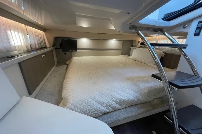 Then Again Yacht Photos Pics Luxurious interior of 2021 Regal 33 XO yacht with cozy bed and modern amenities.