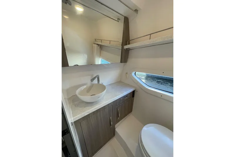 Then Again Yacht Photos Pics 2021 Regal 33 XO yacht bathroom with modern sink, mirror, and window view.