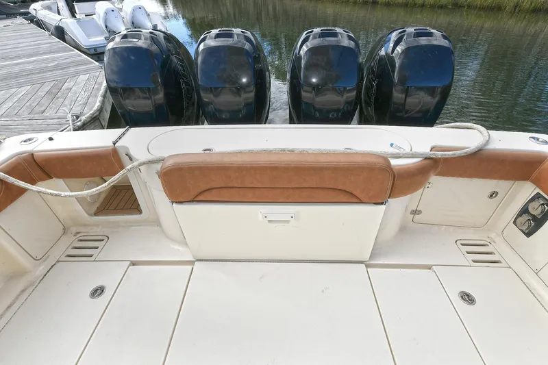  Yacht Photos Pics 2016 Scout 420 LXF boat with four powerful outboard engines docked by the water.