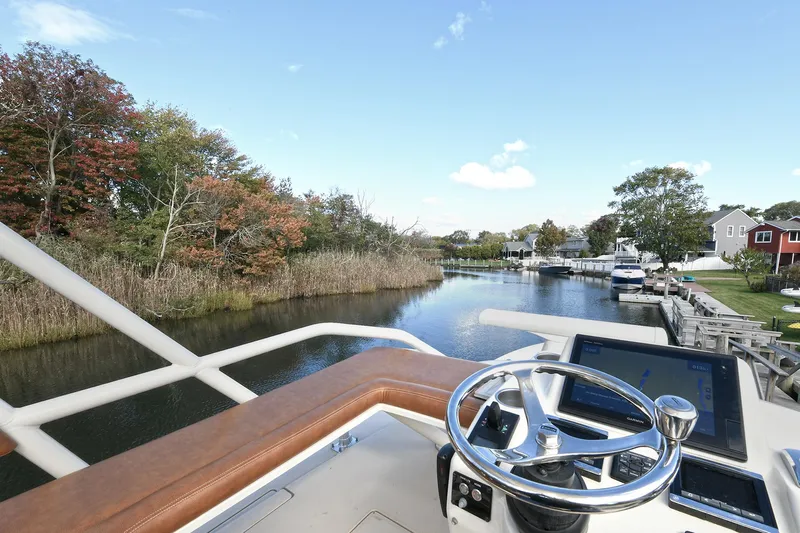  Yacht Photos Pics Helm view from 2016 Scout 420 LXF boat on a scenic river.