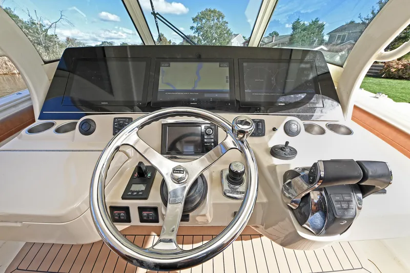  Yacht Photos Pics Helm of 2016 Scout 420 LXF boat with modern navigation controls and steering wheel.