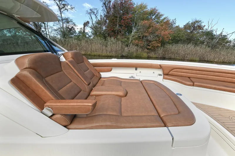  Yacht Photos Pics Luxurious seating on 2016 Scout 420 LXF boat with brown leather upholstery.