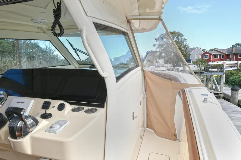  Yacht Photos Pics 2016 Scout 420 LXF boat cockpit with modern controls and scenic marina view.
