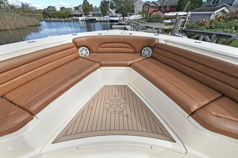  Yacht Photos Pics Luxurious seating area on a 2016 Scout 420 LXF boat, featuring brown leather upholstery.