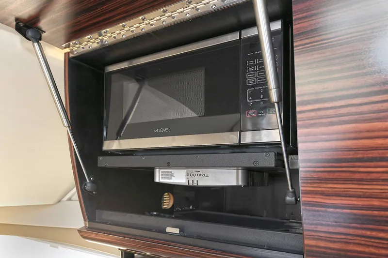  Yacht Photos Pics Built-in microwave in 2016 Scout 420 LXF yacht's wooden cabinet.