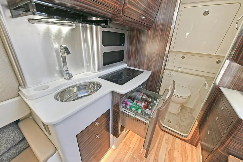  Yacht Photos Pics 2016 Scout 420 LXF yacht interior with kitchenette, sink, and compact bathroom.