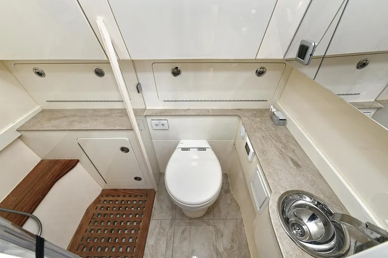  Yacht Photos Pics Luxurious bathroom in 2016 Scout 420 LXF boat with modern fixtures and elegant design.