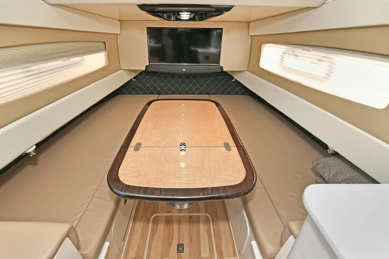  Yacht Photos Pics Luxurious interior of 2016 Scout 420 LXF boat with elegant wood table and seating.