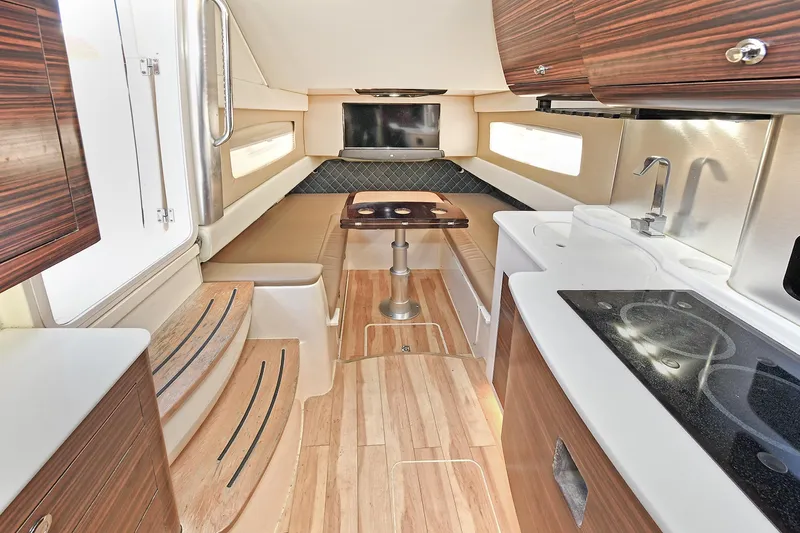  Yacht Photos Pics Luxurious interior of 2016 Scout 420 LXF boat with modern kitchen and seating area.