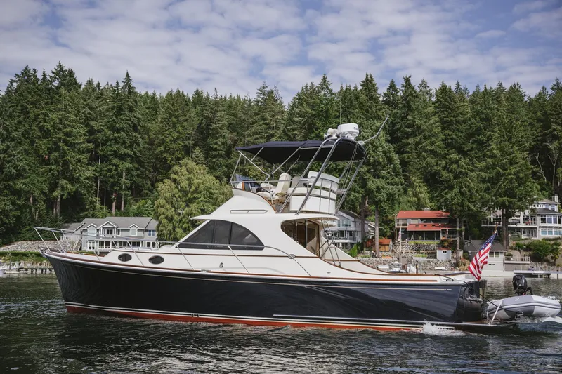 Mm Yacht Photos Pics 2010 San Juan SJ40FB IPS yacht cruising near forested shoreline.