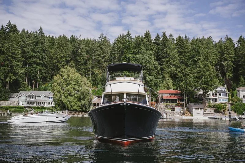 Mm Yacht Photos Pics 2010 San Juan SJ40FB IPS yacht on a serene lake with forested shoreline.