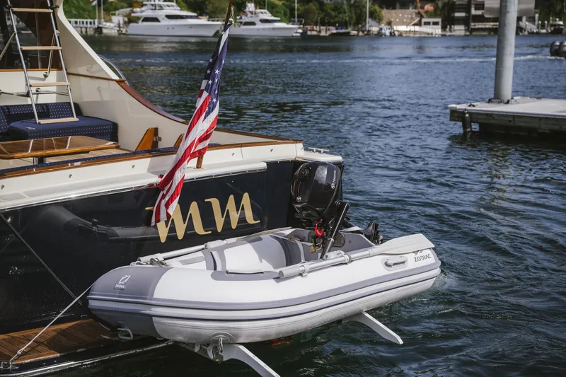 Mm Yacht Photos Pics A 2010 San Juan SJ40FB IPS yacht with an American flag and attached dinghy.