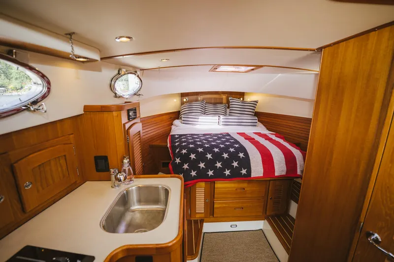 Mm Yacht Photos Pics 2010 San Juan SJ40FB IPS yacht interior with American flag bedding and wooden cabinetry.
