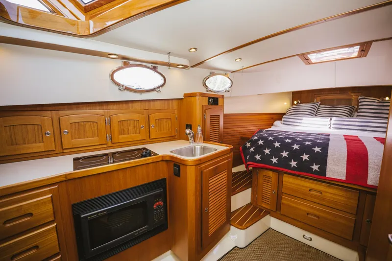 Mm Yacht Photos Pics Luxurious 2010 San Juan SJ40FB IPS yacht interior with wood cabinetry and American flag bedding.