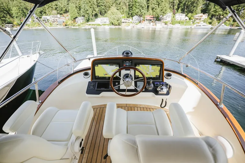 Mm Yacht Photos Pics Helm of 2010 San Juan SJ40FB IPS yacht with dual screens, overlooking serene waters.