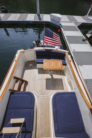 Mm Yacht Photos Pics 2010 San Juan SJ40FB IPS boat with blue seating and wooden table, docked by the water.