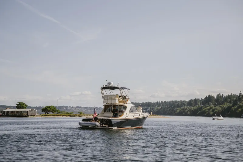 Mm Yacht Photos Pics San Juan SJ40FB IPS 2010 boat cruising on a calm lake with scenic background.