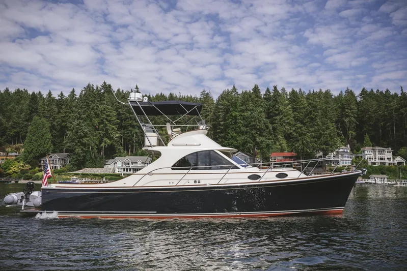 Mm Yacht Photos Pics Elegant 2010 San Juan SJ40FB IPS yacht cruising on a scenic lake with forested shoreline.