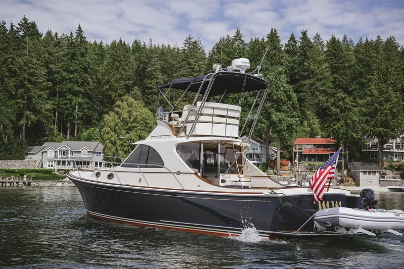 Mm Yacht Photos Pics 2010 San Juan SJ40FB IPS yacht cruising on a scenic lake with forested shoreline.