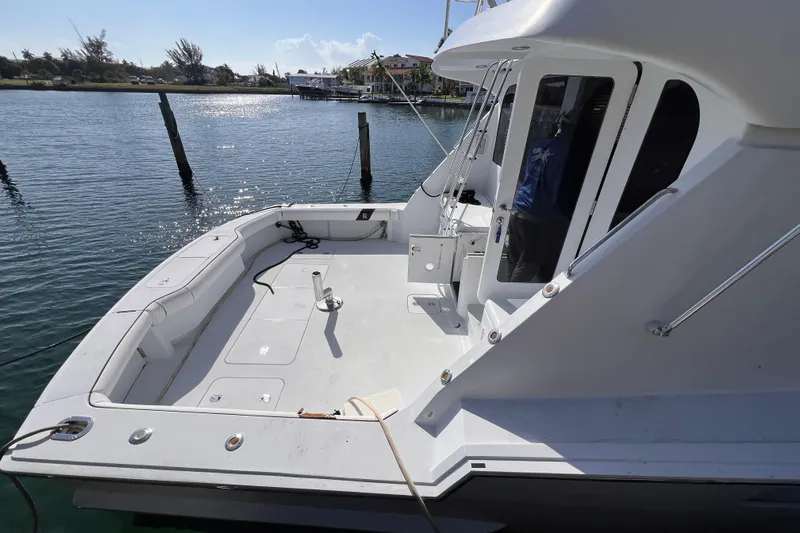 Renegade Yacht Photos Pics 2001 Hatteras 65 Convertible yacht docked, showcasing spacious deck and sleek design.