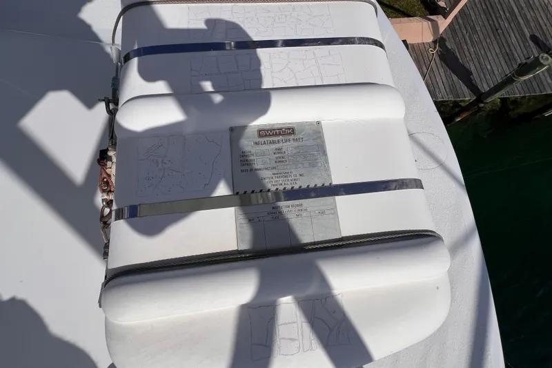 Renegade Yacht Photos Pics Inflatable life raft on 2001 Hatteras 65 Convertible yacht deck, secured with straps.
