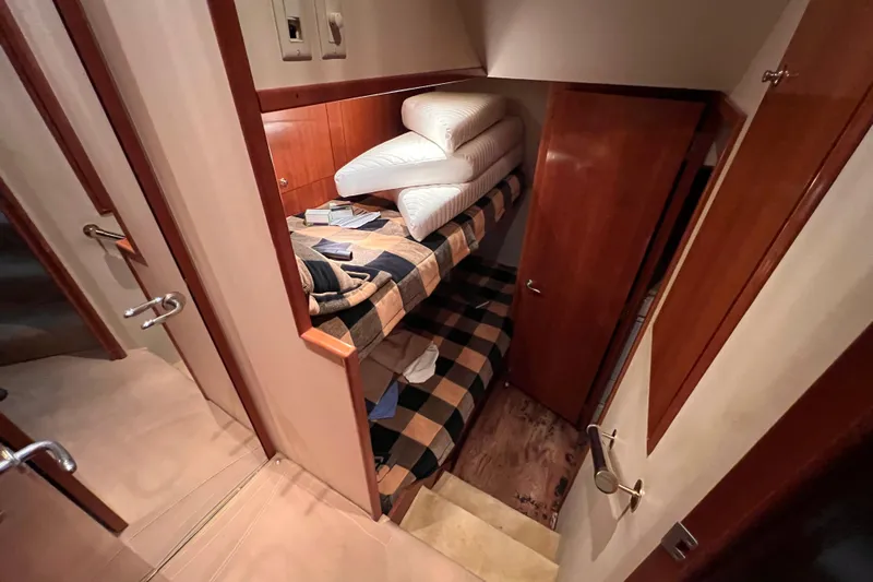 Renegade Yacht Photos Pics Interior of 2001 Hatteras 65 Convertible yacht with bunk beds and wooden finishes.