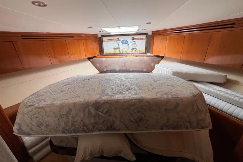 Renegade Yacht Photos Pics Luxurious cabin interior of 2001 Hatteras 65 Convertible yacht with wooden cabinetry.