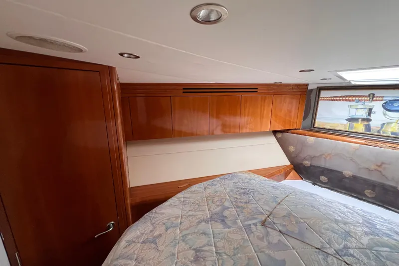 Renegade Yacht Photos Pics Luxurious cabin interior of 2001 Hatteras 65 Convertible yacht with wood paneling.