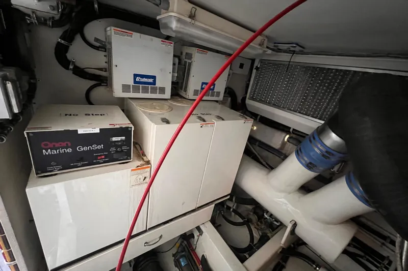 Renegade Yacht Photos Pics Engine room of 2001 Hatteras 65 Convertible with Onan Marine GenSet and Cruisair systems.