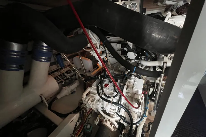 Renegade Yacht Photos Pics Engine room of 2001 Hatteras 65 Convertible yacht, showcasing complex machinery and piping.