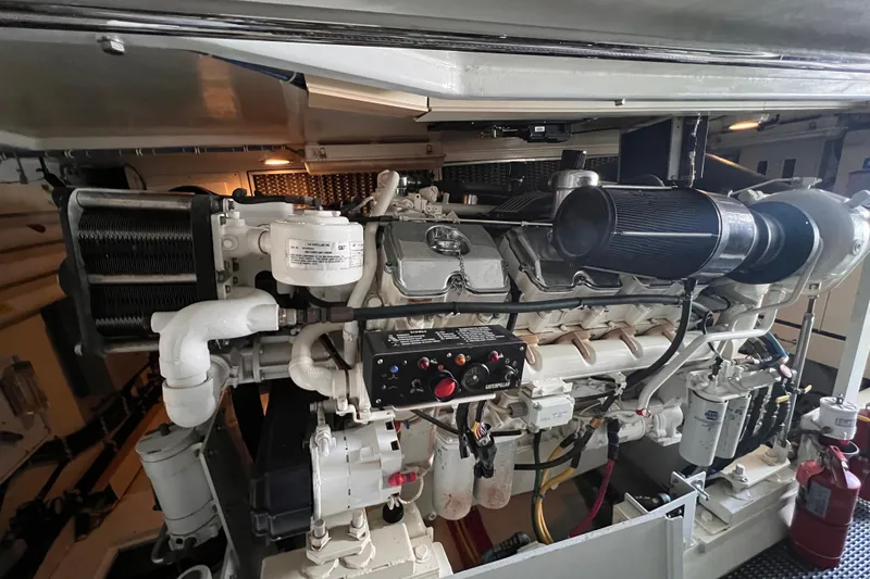 Renegade Yacht Photos Pics Engine room of a 2001 Hatteras 65 Convertible yacht, featuring a powerful marine engine.