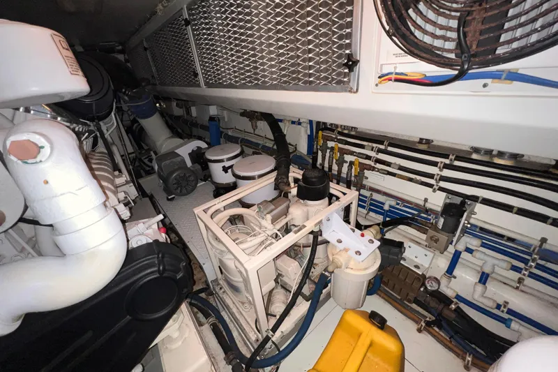 Renegade Yacht Photos Pics Engine room of 2001 Hatteras 65 Convertible yacht, showcasing mechanical components and wiring.