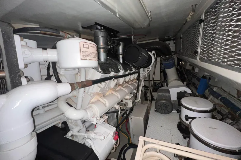 Renegade Yacht Photos Pics Engine room of 2001 Hatteras 65 Convertible yacht, showcasing mechanical components and systems.