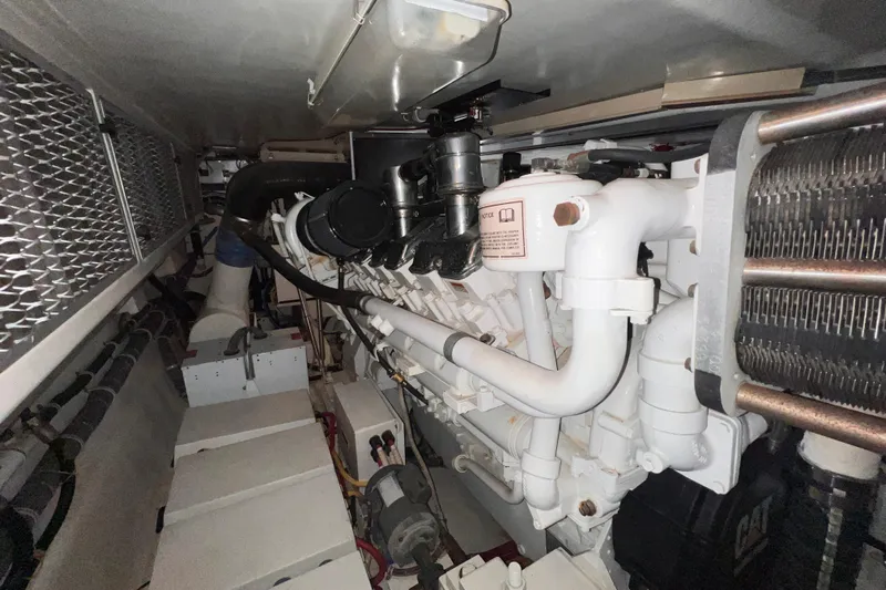 Renegade Yacht Photos Pics Engine room of 2001 Hatteras 65 Convertible yacht, showcasing mechanical components.