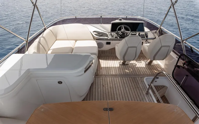 Yacht Photos Pics Luxurious 2023 Princess 45 yacht interior with modern seating and navigation controls.
