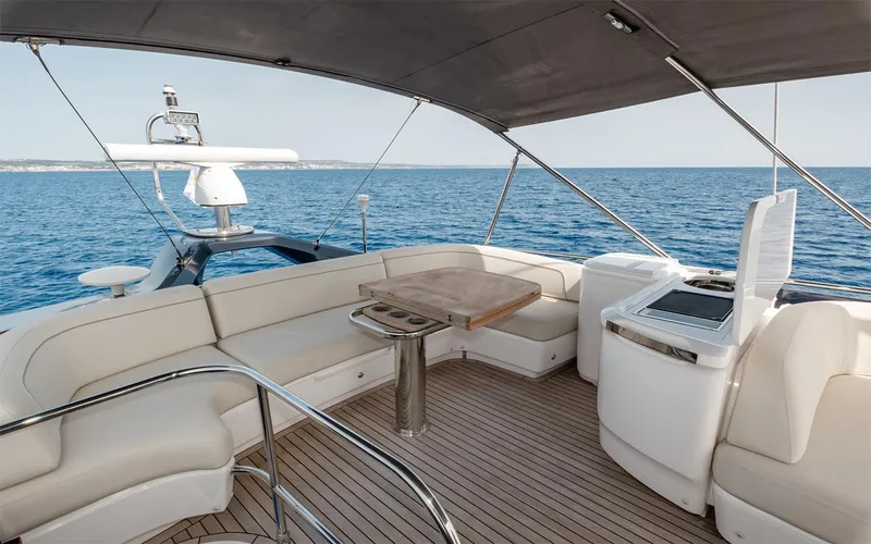  Yacht Photos Pics Luxurious 2023 Princess 45 yacht deck with seating, table, and ocean view.