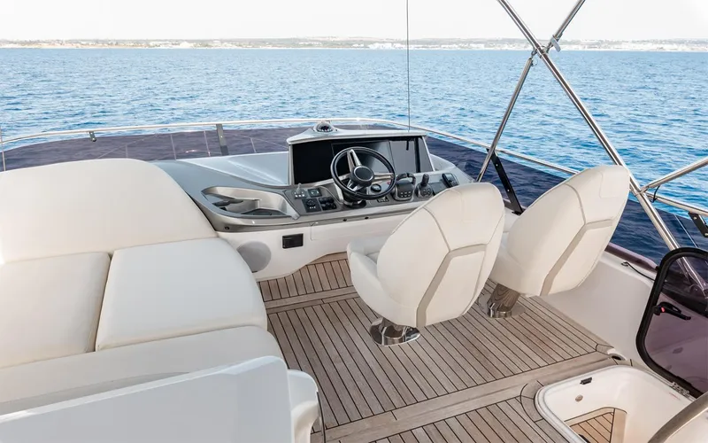  Yacht Photos Pics Luxurious 2023 Princess 45 yacht helm with plush seating and ocean view.