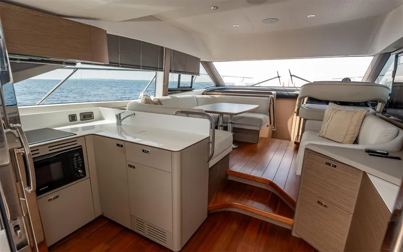  Yacht Photos Pics Luxurious interior of 2023 Princess 45 yacht with modern kitchen and seating area.