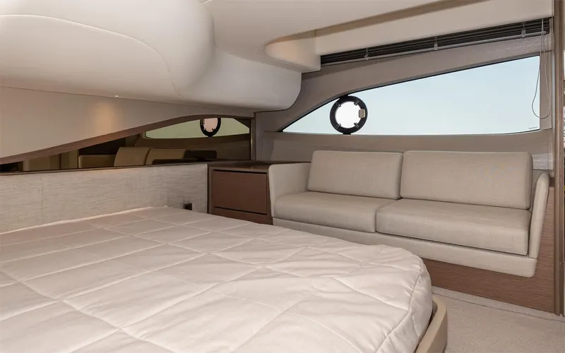  Yacht Photos Pics Luxurious interior of 2023 Princess 45 yacht with bed and sofa.