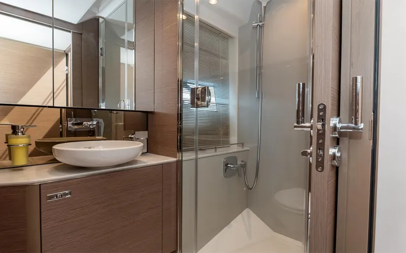  Yacht Photos Pics Modern bathroom in 2023 Princess 45 yacht with glass shower and sleek fixtures.