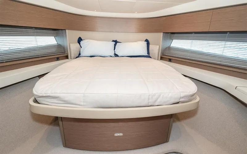  Yacht Photos Pics Luxurious bedroom interior of 2023 Princess 45 yacht with modern design and comfortable bedding.