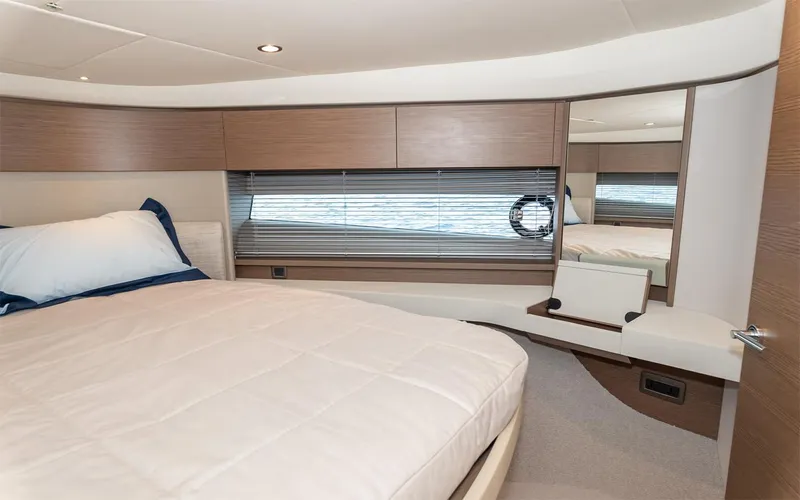  Yacht Photos Pics Luxurious cabin interior of 2023 Princess 45 yacht with modern design and comfortable bedding.