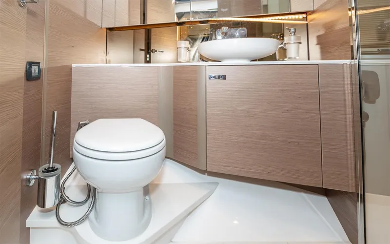  Yacht Photos Pics Modern bathroom in 2023 Princess 45 yacht with sleek fixtures and wooden cabinetry.