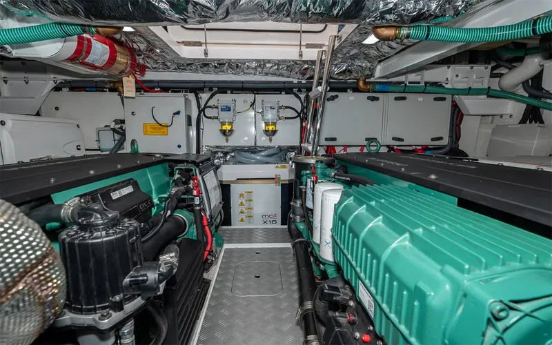  Yacht Photos Pics Engine room of 2023 Princess 45 yacht with dual green engines and safety equipment.