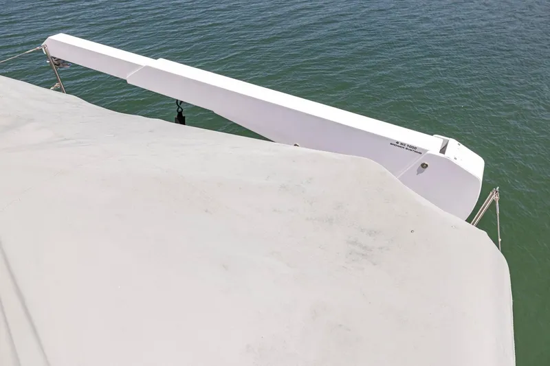 Ds Gatos Yacht Photos Pics White boat deck with crane arm over water, Symbol 558, 1999 model.