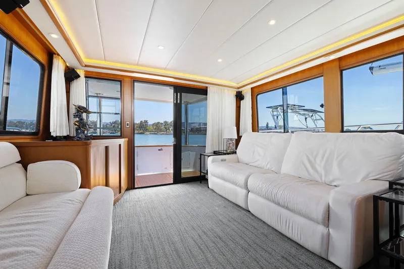 Ds Gatos Yacht Photos Pics Luxurious yacht interior with white sofas, large windows, and scenic water views, Symbol 558, 1999.