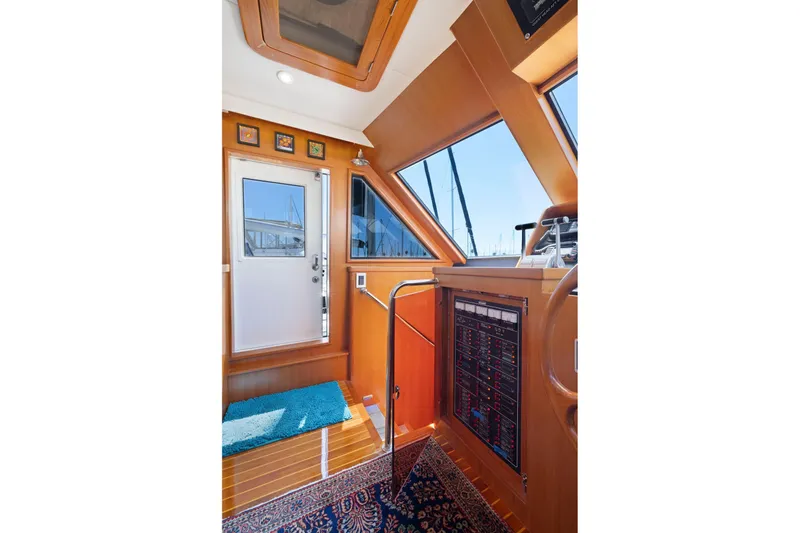 Ds Gatos Yacht Photos Pics Interior of a 1999 Symbol 558 yacht with wooden paneling and control panel.