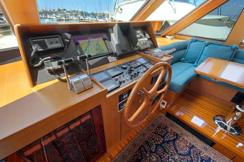 Ds Gatos Yacht Photos Pics Luxurious yacht helm with wooden steering wheel, navigation controls, and plush seating, Symbol 558, 1999.