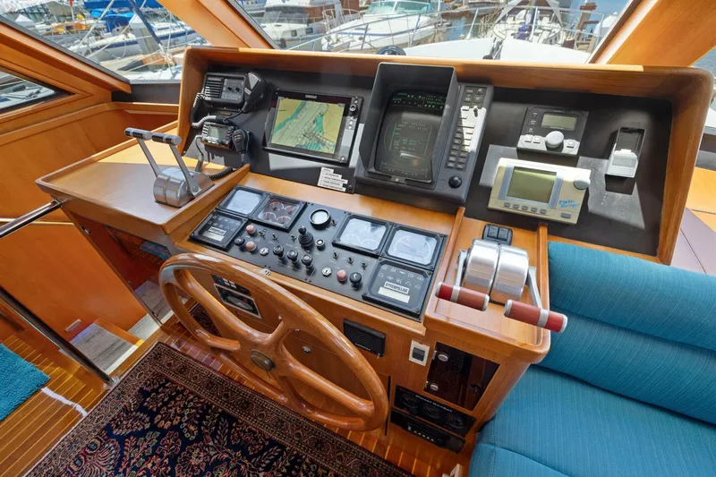 Ds Gatos Yacht Photos Pics Helm of a 1999 Symbol 558 yacht with navigation equipment and wooden steering wheel.