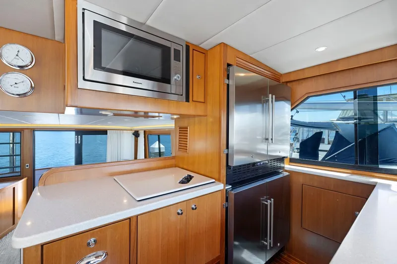 Ds Gatos Yacht Photos Pics Luxurious yacht kitchen interior with modern appliances, wood cabinetry, and ocean view. Symbol 558, 1999.